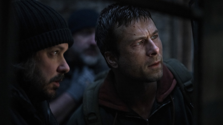 Director Edgar Wright standing next to Glen Powell as Ben Richards on the set of The Running Man