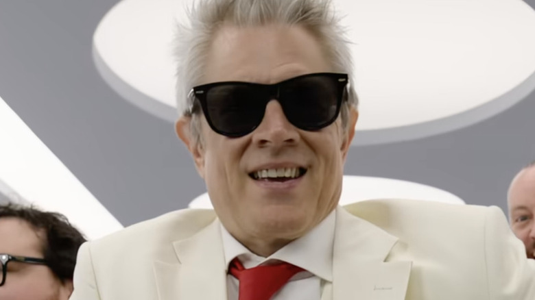 A gray-haired Johnny Knoxville sports shades and a white suit in Jackass: Best and Last