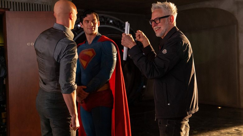 Nicholas Hoult as Lex Luthor, David Corenswet as Superman, and director James Gunn laughing between takes in a behind-the-scenes still from Superman