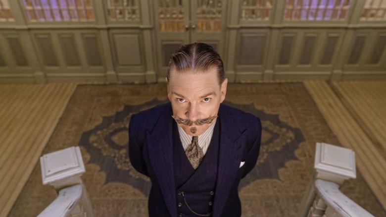 Hercule Poirot at the bottom of the stairs in death on the Nile