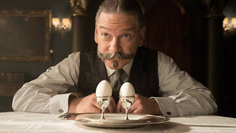 Hercule Poirot with two cups of eggs in front of him in the murder on the East Express