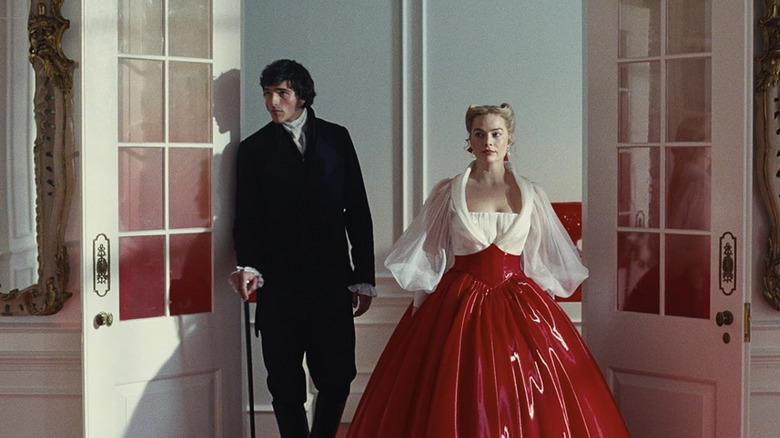 Heathcliff and Cathy dressed nicely, entering a room in Wuthering Heights