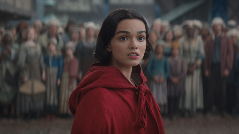 Rachel Zegler as Snow White wearing a red cloak in Snow White (2025)