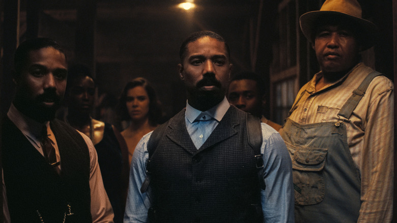 Smoke, Stack, Annie, Mary, Sammie, and Cornbread standing in the juke joint entrance in Sinners