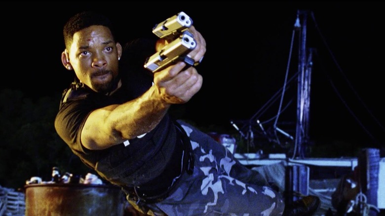 Detective Mike Lowrey firing two guns while flying through the air in Bad Boys II