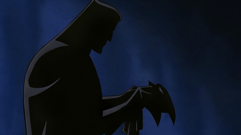 Batman: Mask of the Phantasm - Bruce Wayne in shadow holding Batman mask