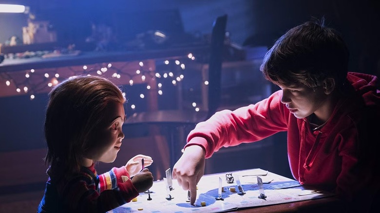 Chucky (Mark Hamill) plays a board game with Andy Barclay (Gabriel Bateman) in Child's Play (2019)