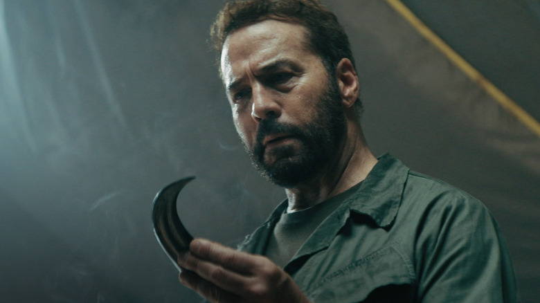 Jeremy Piven as Colonel Jericho holding a raptor claw in Primitive War