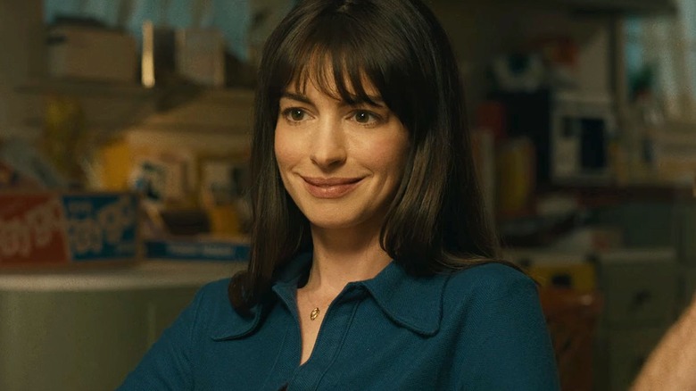 Denise Platt smiling while sitting at a dining table in The End of Oak Street