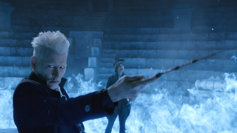 Grindelwald holding a wand iun a circle of blue flame in Fantastic Beasts: The Crimes of Grindelwald