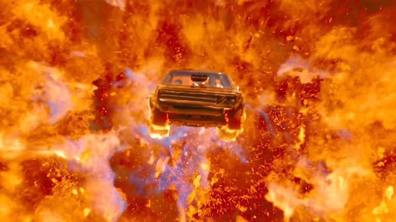 A car drives through flames and an explosion in Fast X