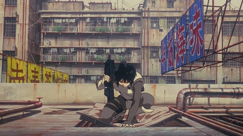 Major Kusanagi lands on the ground and breaks a metal panel in Ghost in the Shell