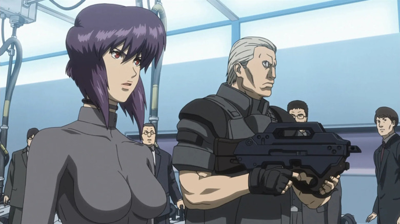 Major stands next to Batou who is holding a rifle in Ghost in the Shell: Stand Alone Complex – Solid State Society