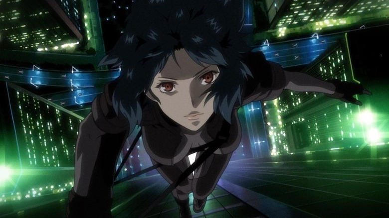 Makoto climbs up a building in Ghost in the Shell: Stand Alone Complex