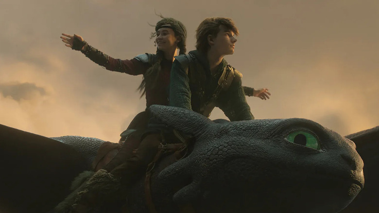 Hiccup and Astrid flying on the back of Toothless in How to Train Your Dragon (2025)