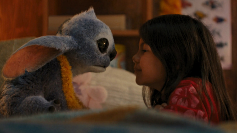 Stitch looks into the eyes of Lilo (Maia Kealoha) in Lilo & Stitch (2025)