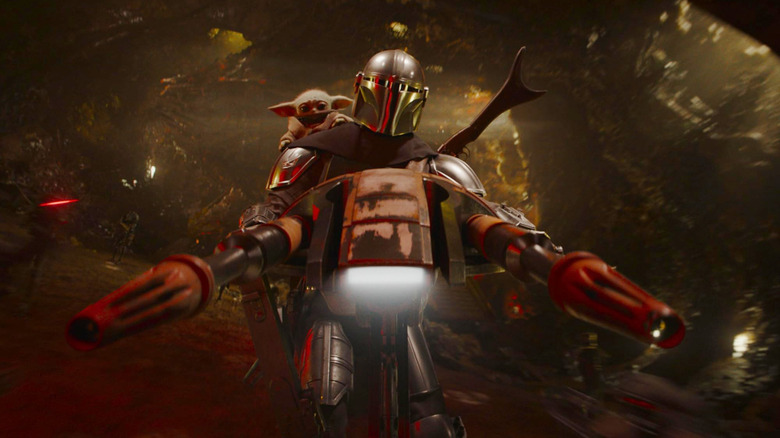 Pedro Pascal as Din Djarin and Grogu riding a speeder bike in The Mandalorian and Grogu