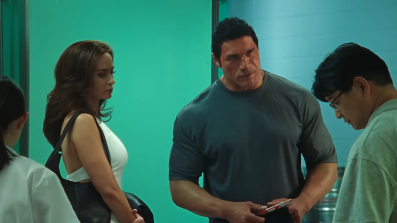 Dawn Staples and Mark Kerr talking to a doctor in The Smashing Machine