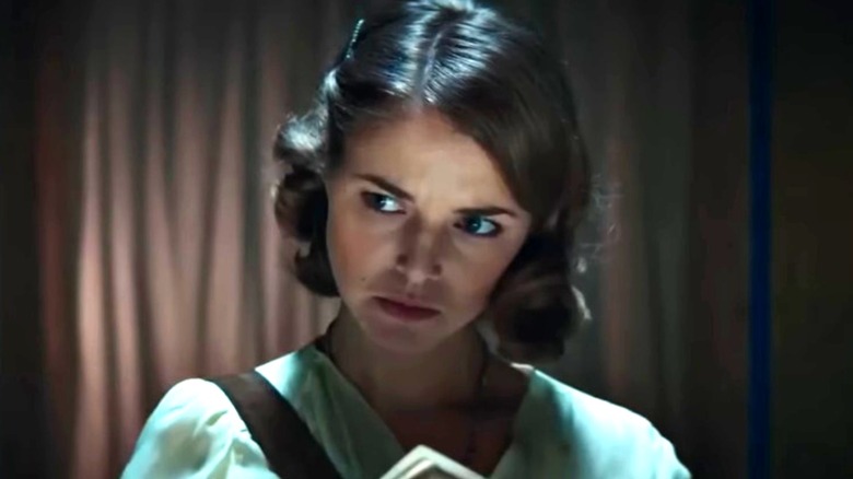 Ellie Gall as Catherine Langford looking to her left with an alarmed expression on Stargate Origins
