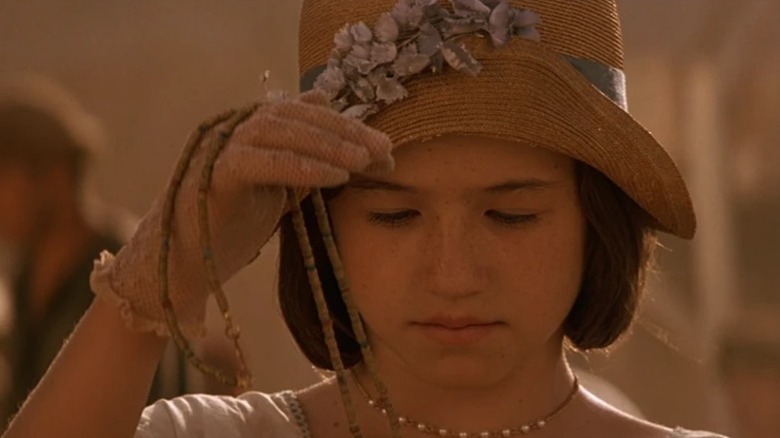 Kelly Vint Castro as Catherine Langford looking down at a necklace she's holding in Stargate