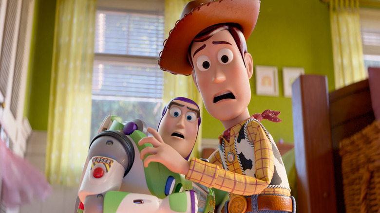 Tim Allen as the voice of Buzz Lightyear and Tom Hanks as the voice of Woody looking at something in shock in a child's bedroom in Toy Story 5