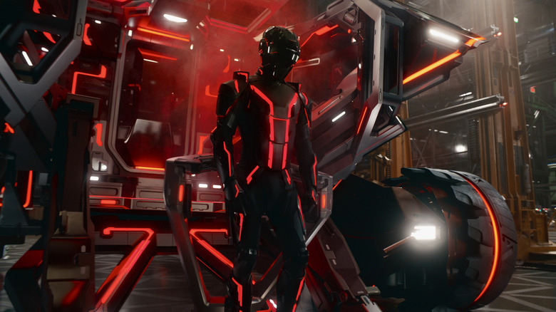 Jared Leto as Ares fully suited up and standing in front of a futuristic backdrop in Tron: Ares