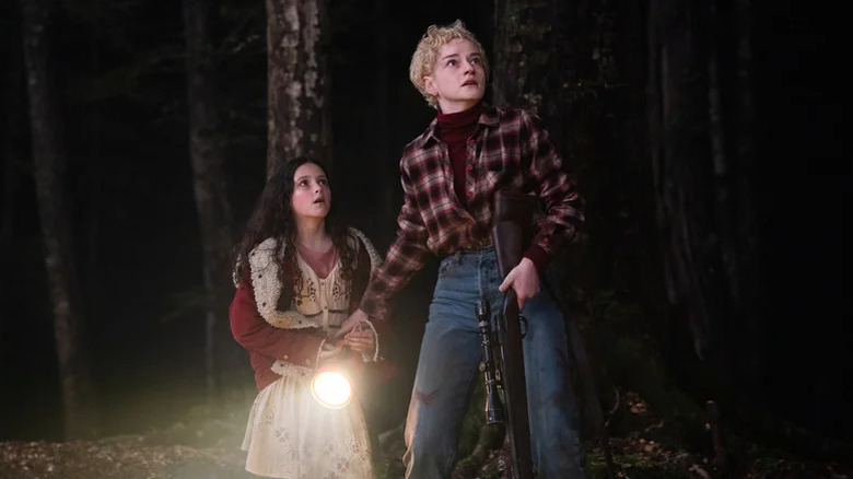 Julia Garner's Charlotte Lovell and Matilda Firth's Ginger Lovell afraid in the forest in Wolf Man