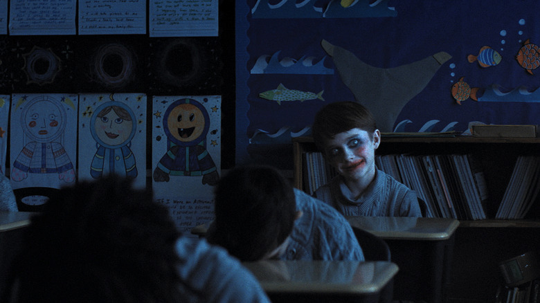 A creeping child sitting in a dark semester with weapons