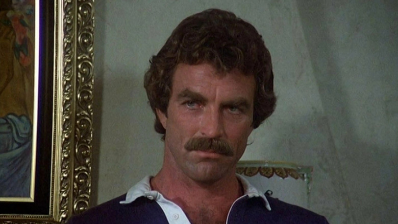 Tom Selleck as Thomas Magnum looks pensive in Magnum, P.I.