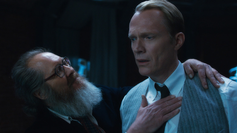 James Spader as Ultron patting the chest of Paul Bettany as Vision in their human avatars in VisionQuest