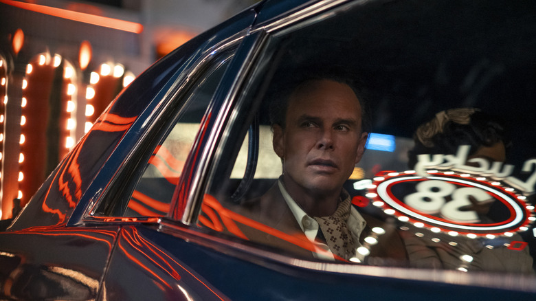 Walton Goggins as Cooper Howard sitting in a car and looking out the window in Las Vegas in Fallout season 2