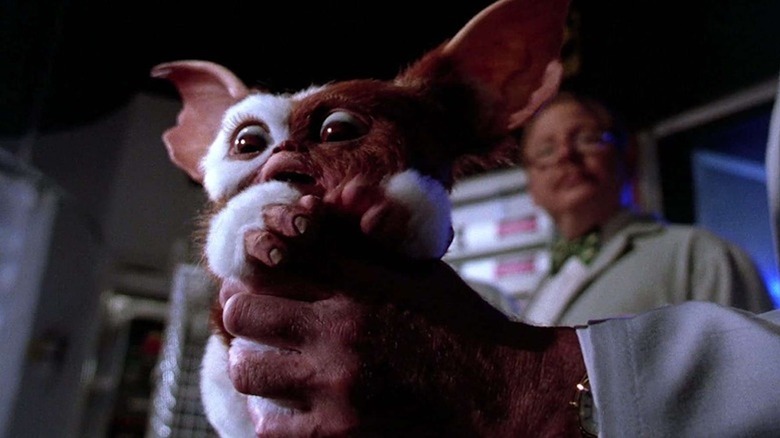 Gizmo is held in the clutches of a scientist in Gremlins 2: The New Batch