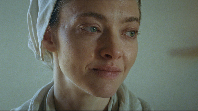 Amanda Seyfried as Ann Lee smiling sadly in The Testament of Ann Lee