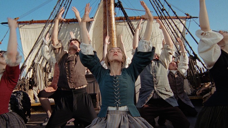 Amanda Seyfried as Ann Lee and her fellow Shakers performing a hymn on a ship in The Testament of Ann Lee