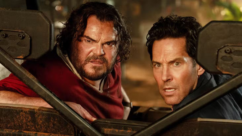 Jack Black as Doug and Paul Rudd as Griff looking backwards in an off-roading vehicle in Anaconda
