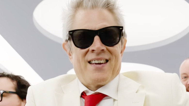 A gray-haired Johnny Knoxville sports shades and a white suit in Jackass: Best and Last