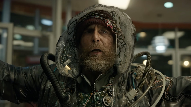 Sam Rockwell as the Man From the Future spreading his arms in Good Luck, Have Fun, Don't Die