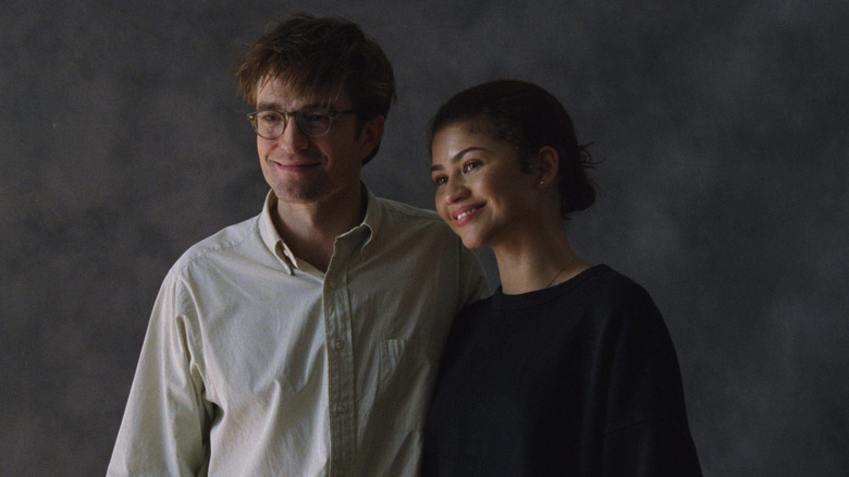 Robert Pattinson as Charlie embracing Zendaya as Emma pose for a photo portrait in The Drama