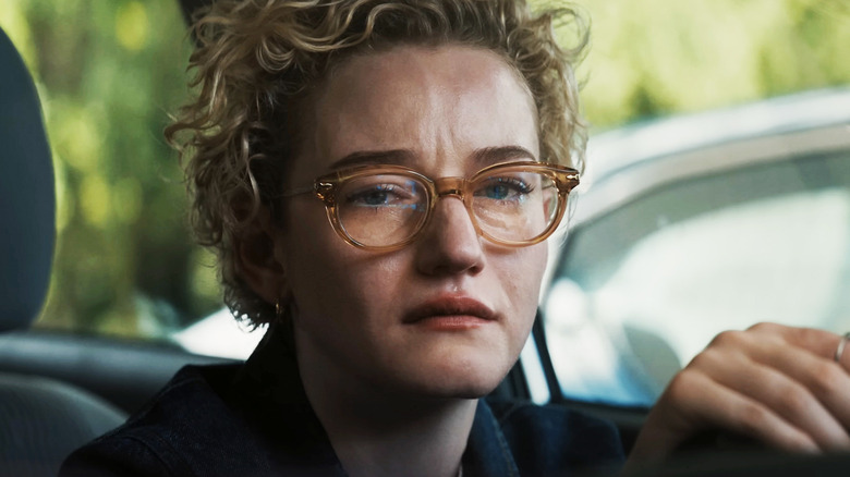 Julia Garner's Justine Gandy sits in her car looking upset in Weapons