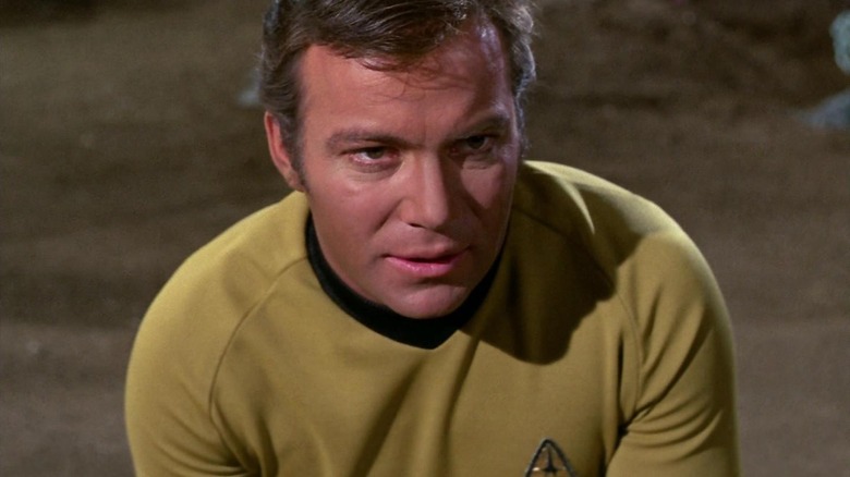 Kirk on the ground looking intense on Star Trek