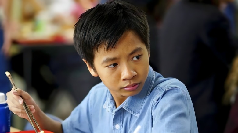 There Nguyen holds wand on young Sheldon