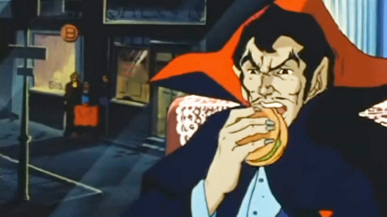 Dracula eating a cheeseburger in Dracula Sovereign of the Damned