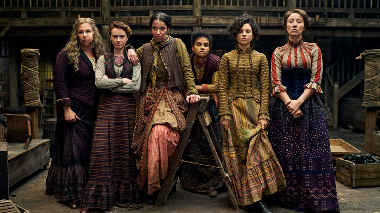 Hannah Walters as Eliza, Jemma Carlton as Belle, Caoilfhionn Dunne as Anne, Morgan Hilaire as Esme, Darci Shaw as Alice, and Erin Doherty as Mary standing in a row in A Thousand Blows