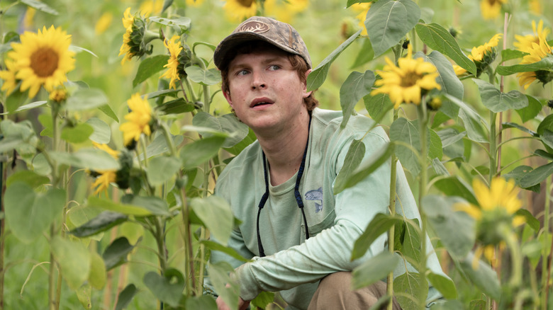 Paul in a sunflower field looking scared in Murdaugh: Death in the Family
