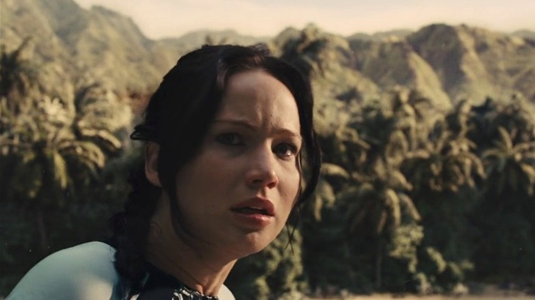 Katniss Everdeen scanning the Hunger Games arena in shock