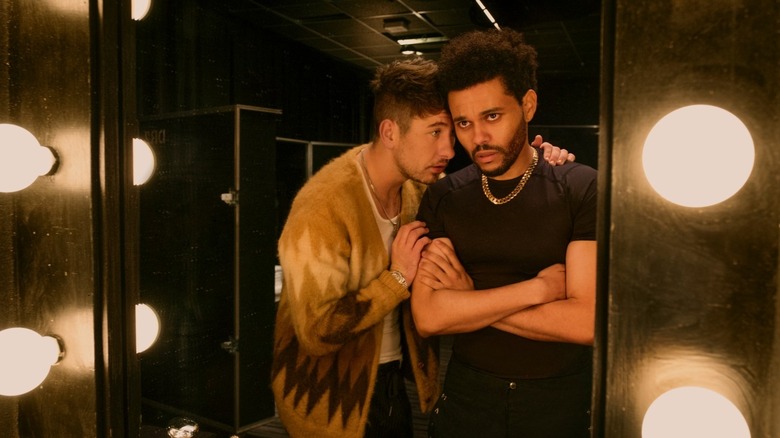 Lee and Abel Tesfaye looking in a mirror, embracing in Hurry Up Tomorrow.