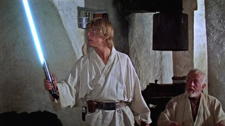A New Hope Luke holding lightsaber 