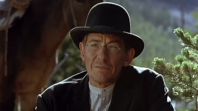 Ian McKellen's Percy Corcoran is seen sitting in front of a horse in The Ballad of Little Jo