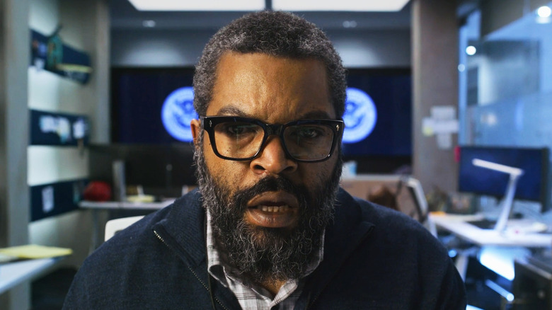 Ice Cube's Will Radford looks shocked as he sits in his office in War of the Worlds