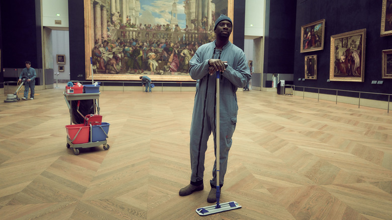Assane working as a janitor in the Louvre on Lupin
